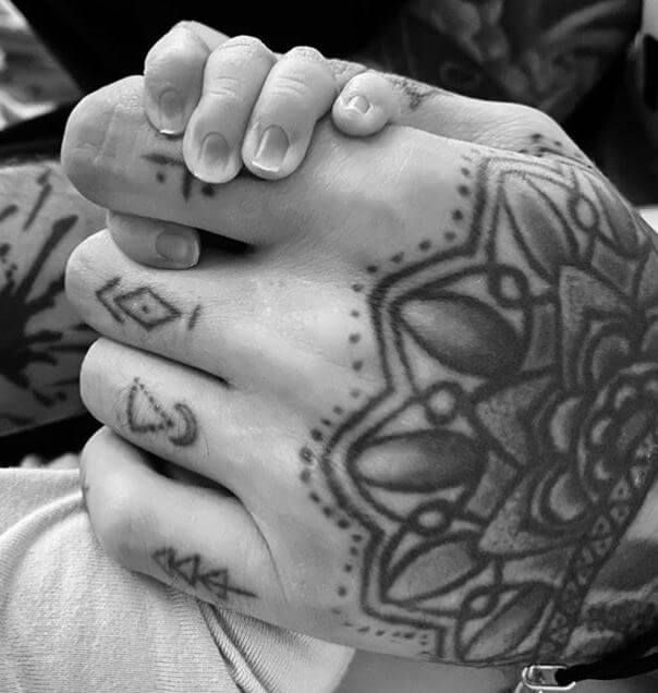 Tricia Brannan Malik’s granddaughter holding her father, Zayn Malik's finger with her little hand.